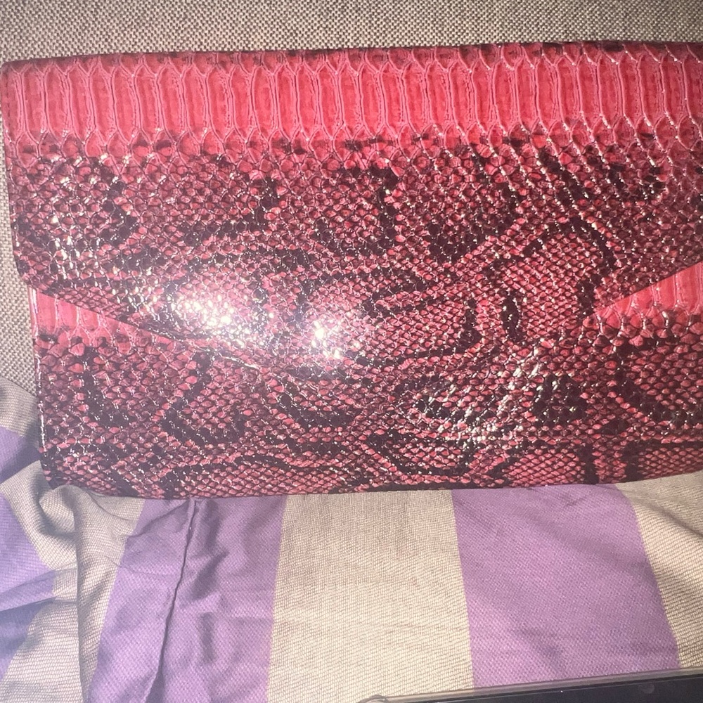 Dark red and black snakeskin printed envelope clutch.